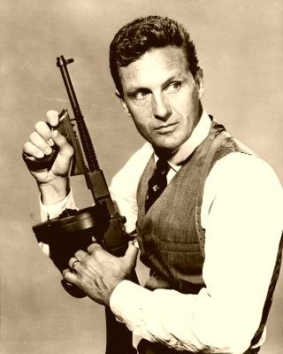 Robert Stack in character as Eliot Ness, holding a Thompson submachine gun, in a 1960 ABC publicity photograph