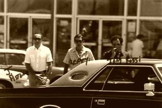 An FBI surveillance photograph of three men standing beside a parked car, annotated in red grease pencil with the names J. Pistone, Lefty and Tony Rossi
